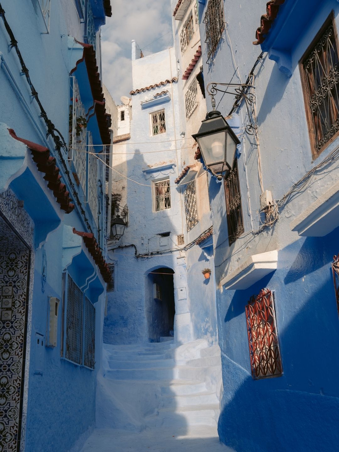 blue-painted alley in Chefchaouen, Morocco.