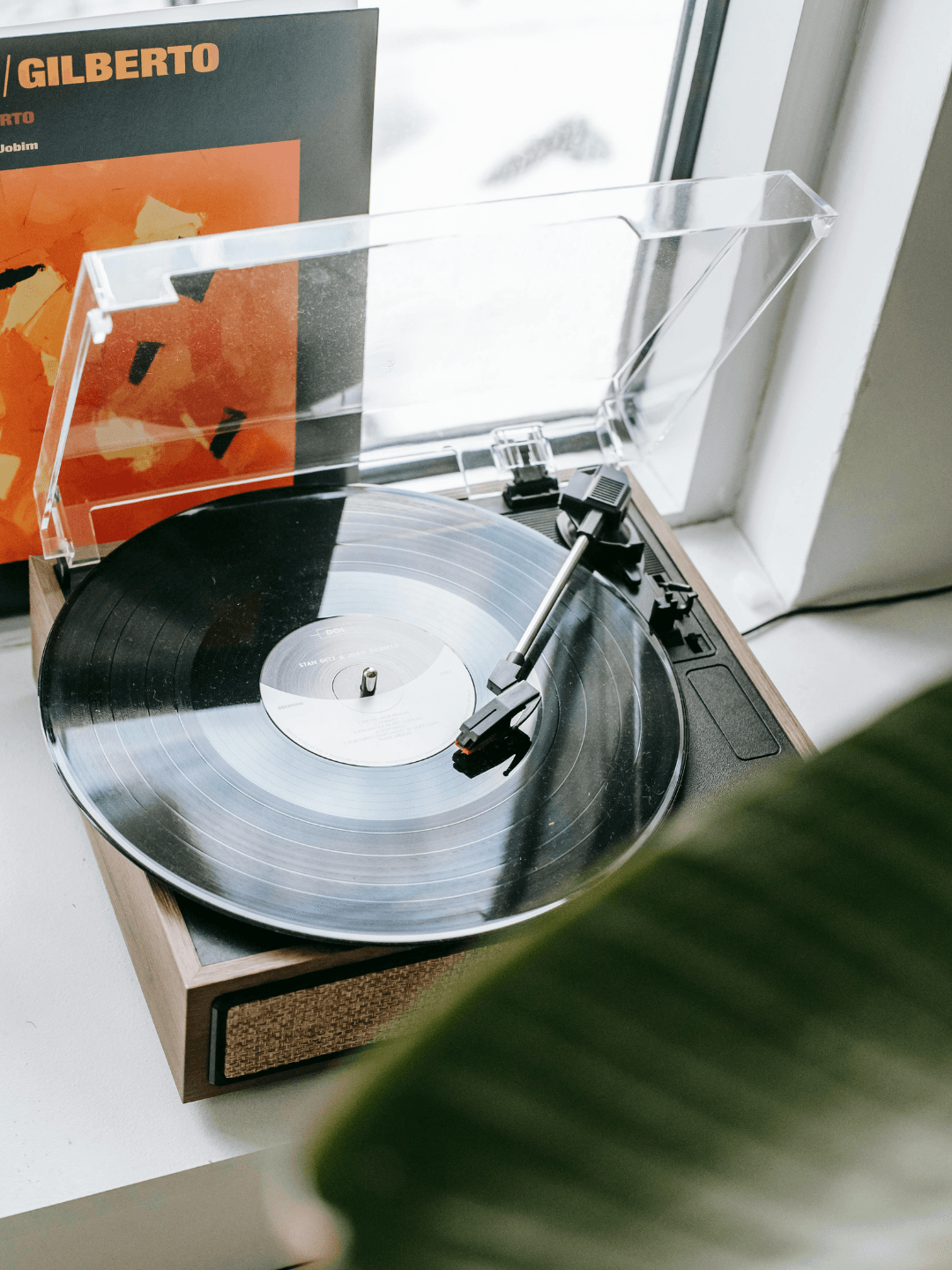 Vintage record player with disc placed on windowsill